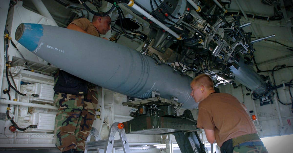 B-2_Staff Sgt. Michael Taylor and Senior Airman Joseph Nelson load a bomb on a B-2 Spirit bomber