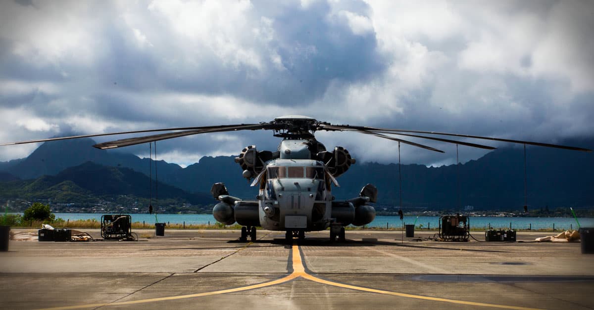 CH-53E_A CH-53E is flanked by pumps and cleaning equipment prior to a detailed aircraft decontamination