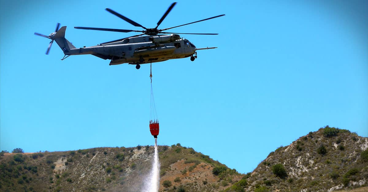 CH-53E_drops water in a mock fire area during an aerial firefighting exercise
